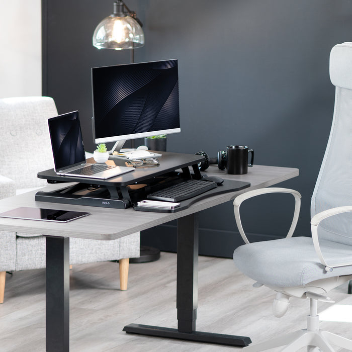 Sturdy height adjustable 2-tiered desk riser for ergonomic office workstation.