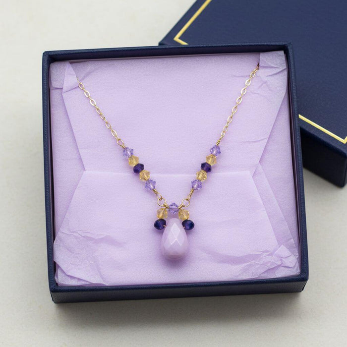 Lavender Candy Jade Drop Gold Wire Wrapped Necklace displayed in a jewelry box with lavender and purple Swarovski crystals.