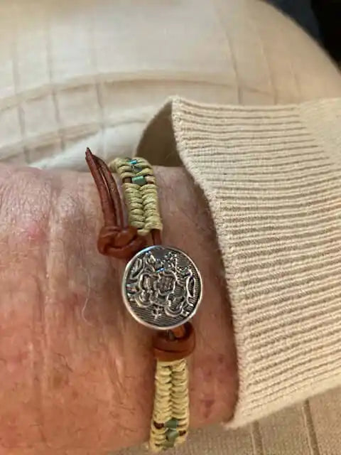 Leather Seed Bead Rattlesnake Tail Weave Bracelet on a wrist showcasing rustic elegance and intricate detailing.