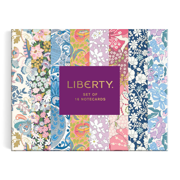 The Liberty Floral Greeting Assortment Notecard Set Volume 2 by Liberty of London Ltd includes 16 notecards with a purple center label and colorful floral borders on a white background.