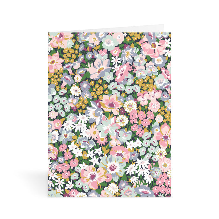 The Liberty Floral Greeting Assortment Notecard Set Volume 2 by Liberty of London Ltd features dense pink, white, yellow, and blue flowers with green leaves on white—perfect for any card set.