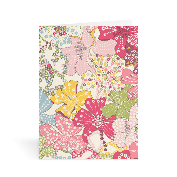 The Liberty Floral Greeting Assortment Notecard Set Volume 2 by Liberty of London Ltd features vibrant cards with colorful floral designs in pink, yellow, green, and blue, accented by delicate dots and patterns on crisp white backgrounds.