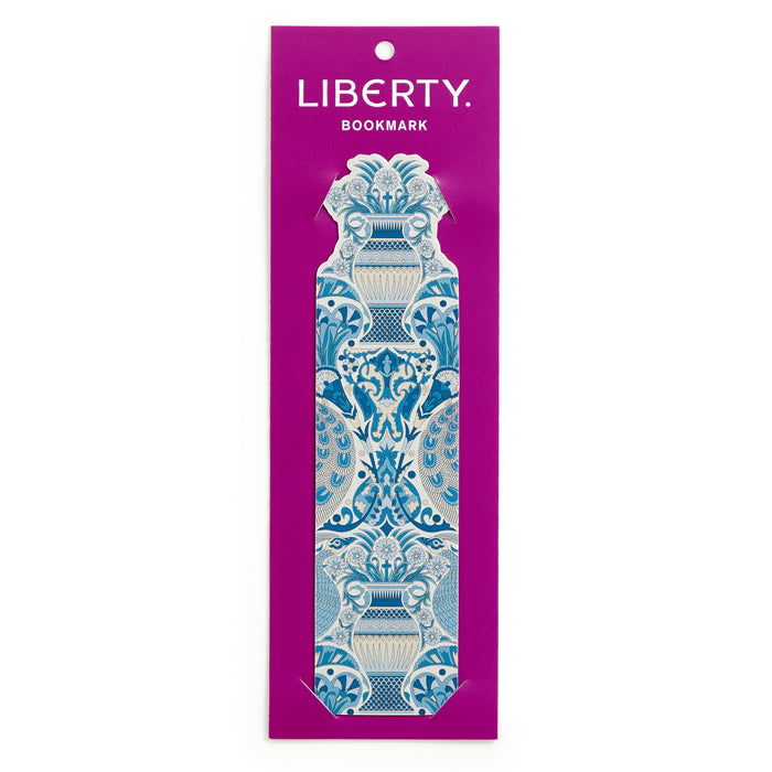 The Liberty Oscars Palace Shaped Bookmark by Liberty of London Ltd features the iconic symmetrical floral and vase print in blue and white, presented on a purple card labeled LIBERTY BOOKMARK at the top.