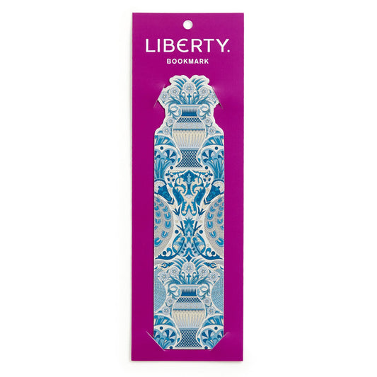 The Liberty Oscars Palace Shaped Bookmark by Liberty of London Ltd features the iconic symmetrical floral and vase print in blue and white, presented on a purple card labeled LIBERTY BOOKMARK at the top.