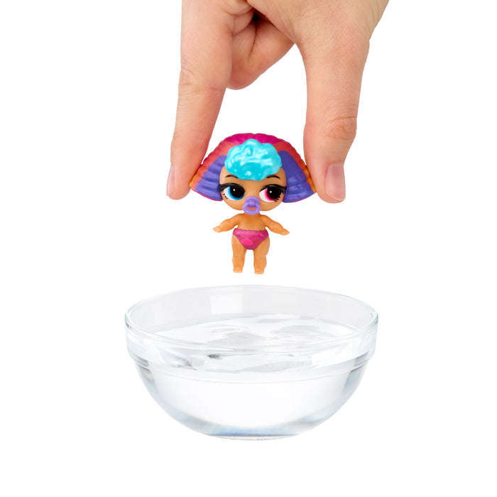 Hand putting small doll into a bowl of water on a white background