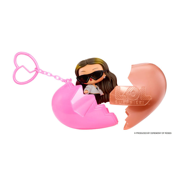 Small doll with heart keychain in two pieces on a white background