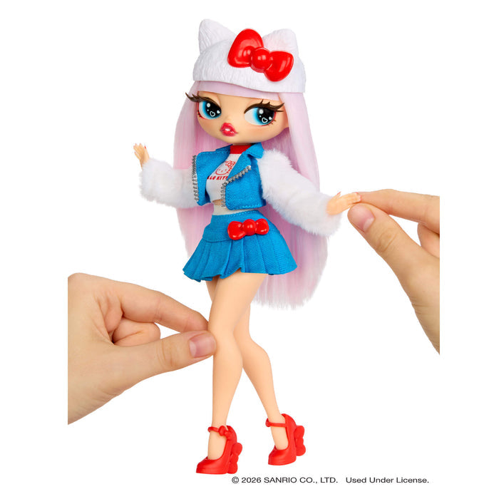 Toy doll with pink hair, blue outfit, and red shoes held by a hand on a white background