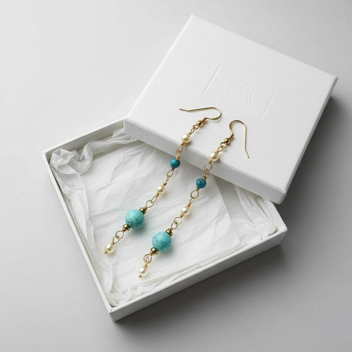 Long 14 K Gold Filled Turquoise Pearl Earrings displayed in a white gift box with tissue paper.