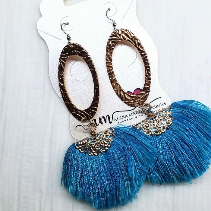 Long Copper Embossed Aqua Brushed Silk Fan Tassel Earrings showcased on display card.