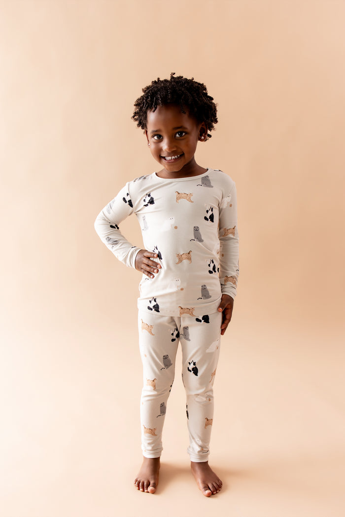 Smiling child posing wearing the Long Sleeve Pajamas in Fluffy Cat