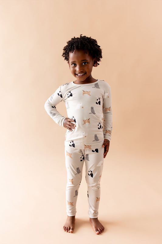 Smiling child posing wearing the Long Sleeve Pajamas in Fluffy Cat