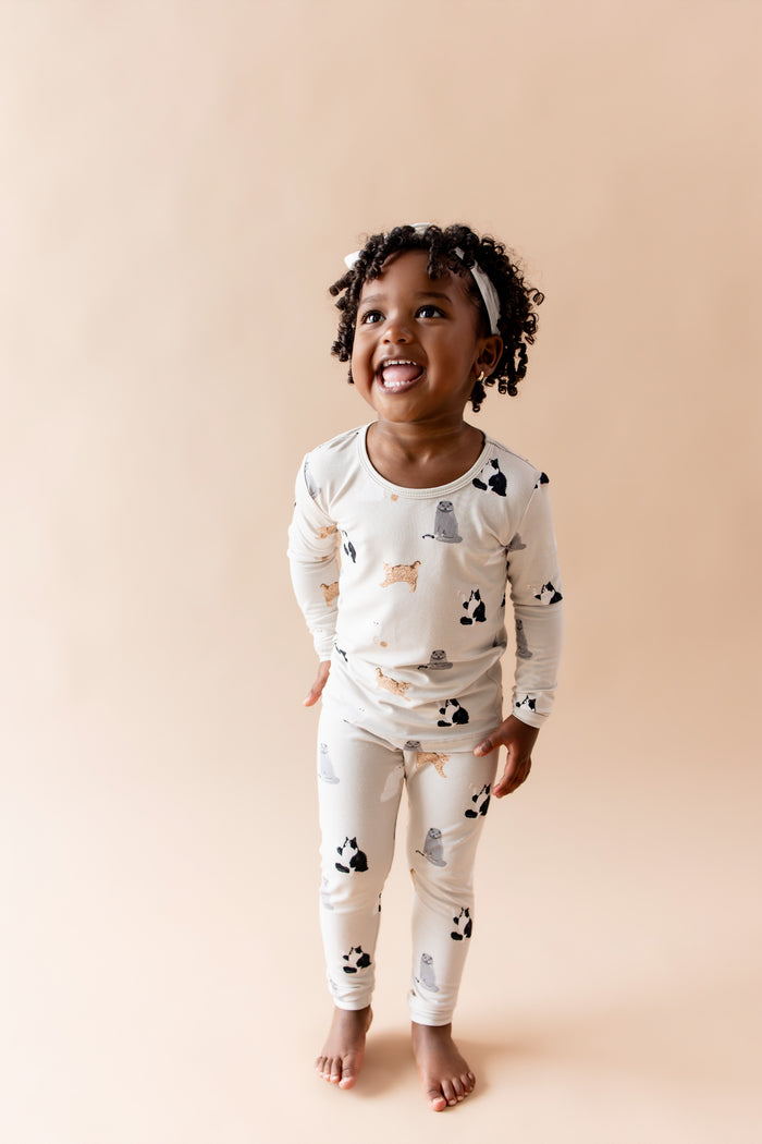 Smiling girl wearing the Long Sleeve Pajamas in Fluffy Cat