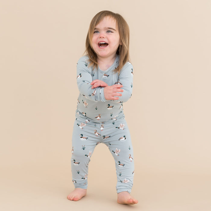 Young smiling child wearing the Long Sleeve Pajamas in Mallard Duck