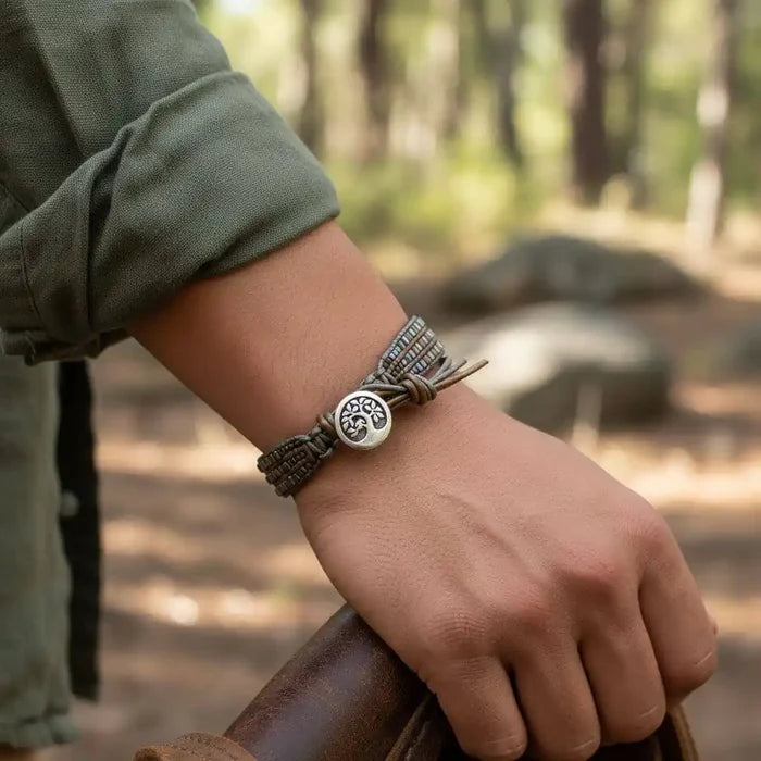 Men's Intricately Beaded Leather Tree of Life Bracelet worn by a person outdoors, showcasing its unique design and craftsmanship.