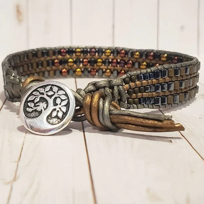 Men's Intricately Beaded Leather Tree of Life Bracelet featuring a decorative tree charm and vibrant beads.
