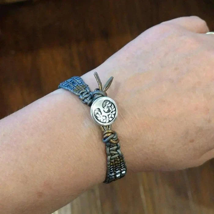Men's Intricately Beaded Leather Tree of Life Bracelet displayed on a wrist, showcasing its unique beadwork and design.