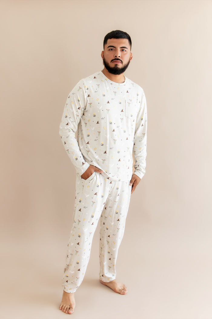 Person wearing a cream men's jogger set with Harry Potter prints on a beige background