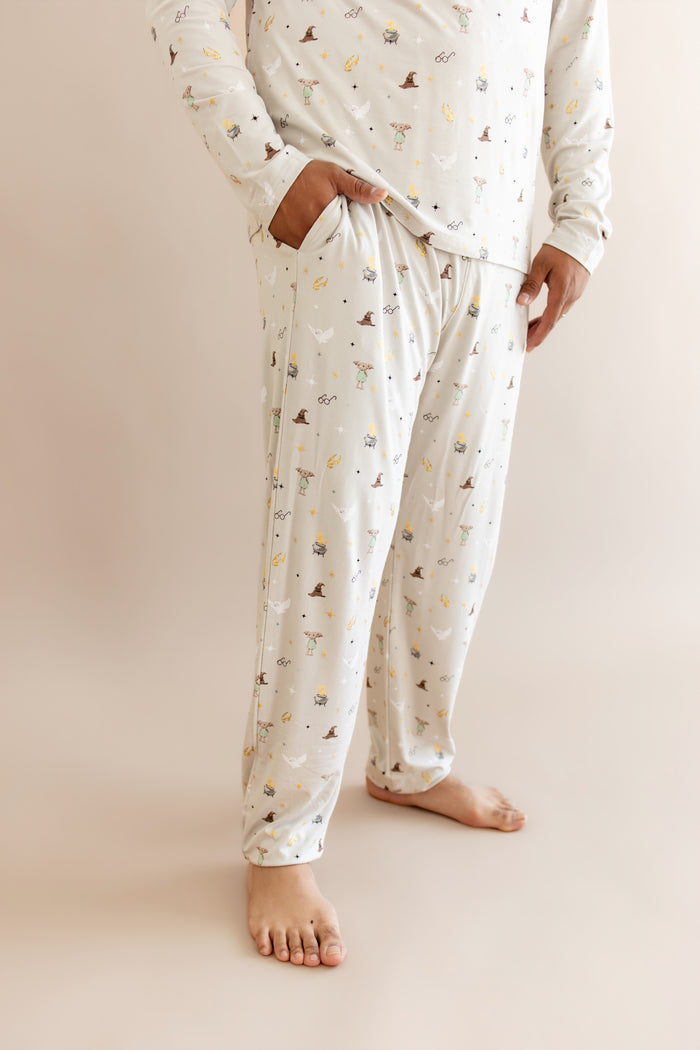 Person wearing men's jogger set pajama with pocket having Harry Potter prints on cream fabric