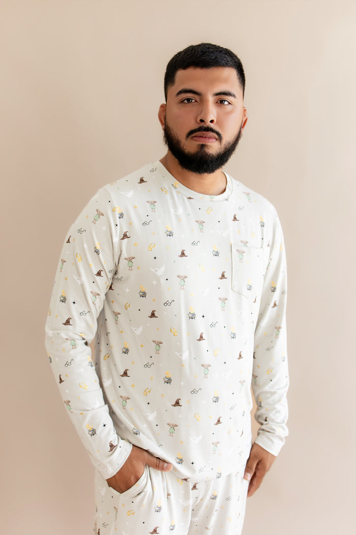 Person wearing a cream Men's jogger set with Harry Potter prints on a beige background