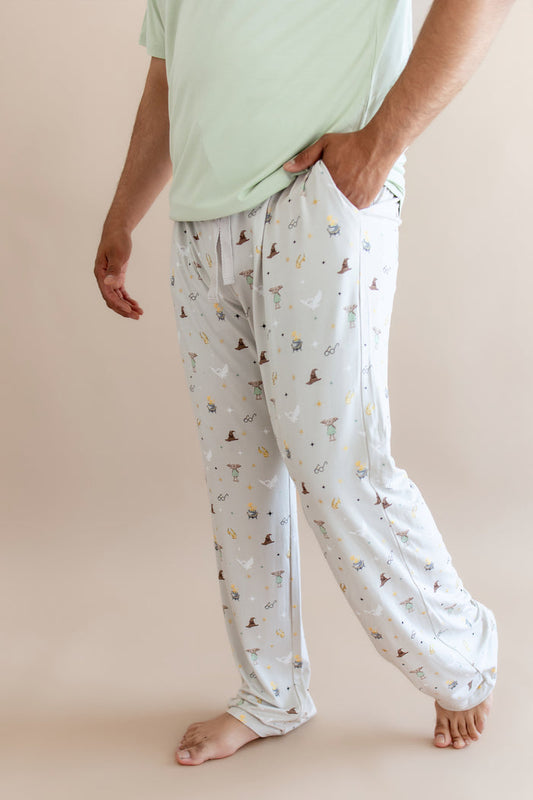 Person wearing a cream men's lounge pant with pocket having Harry Potter prints on a beige background