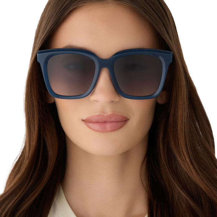 on model - female wearing diff eyewear featuring the meredith square  oversized sunglasses with a clubhouse blue acetate frame and grey gradient polarized lenses front view