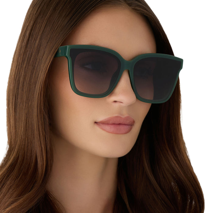 on model - female wearing diff eyewear featuring the meredith ii square oversized sunglasses with a fairway green acetate frame and grey gradient lenses angled view