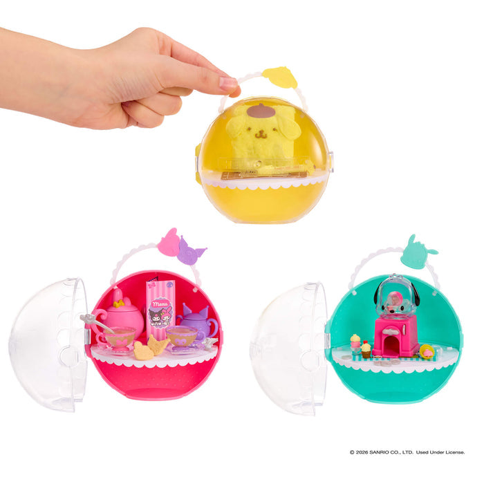 Hand holding a transparent Mini Verse ball with a small toy inside, surrounded by other similar toys on a white background.