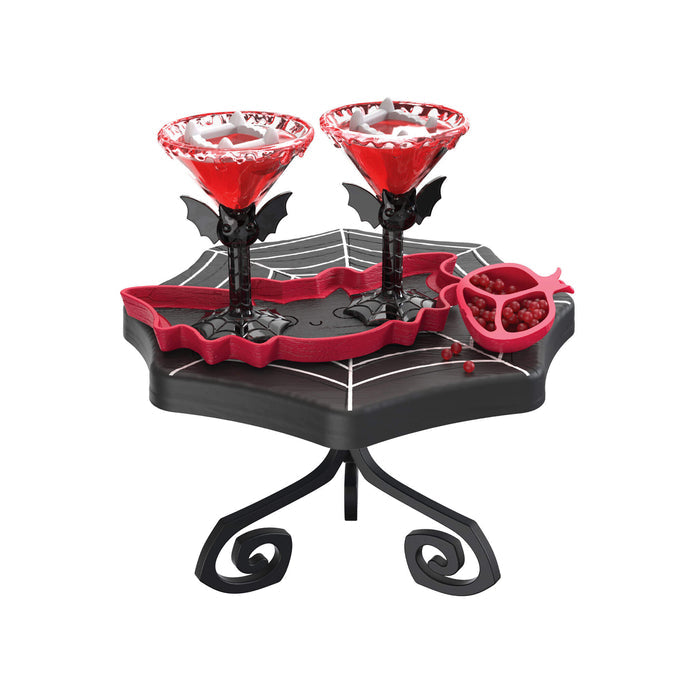 Flower like cups with bat looking stems on a black table on a white background