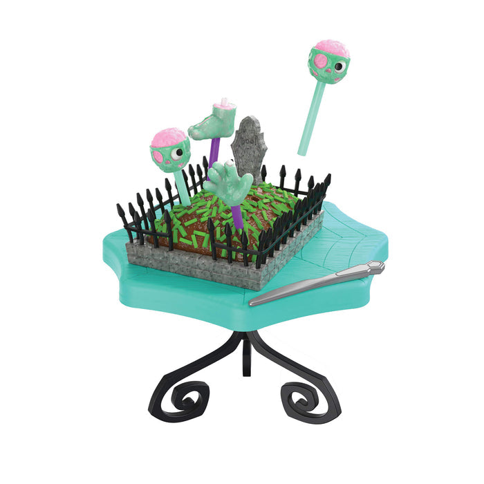 Grave looking cake on a teal color table on a white background