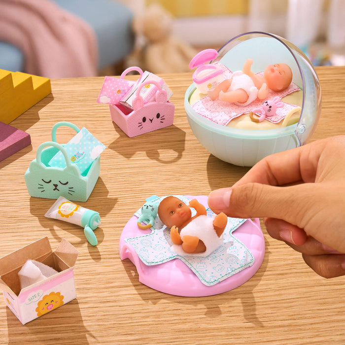 Mini Toy baby set with accessories on a wooden surface