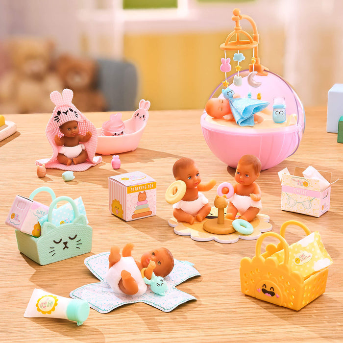 Collection of baby-themed toys on a wooden surface