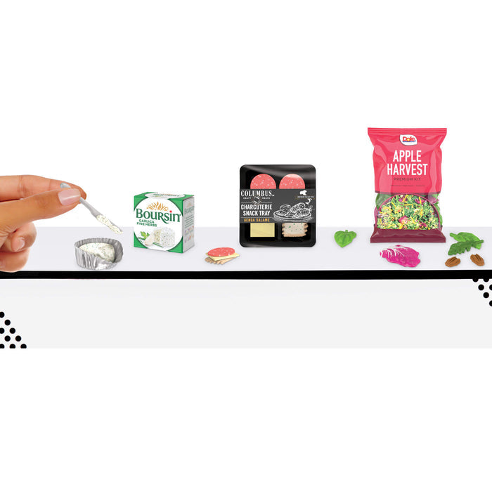 Miniature food packages and a hand with a spoon on a white background