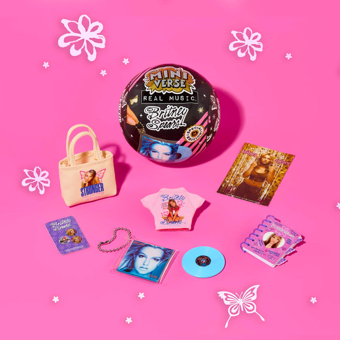 Collection of Britney Spears merchandise including a vinyl record, t-shirt, and accessories on a pink background.