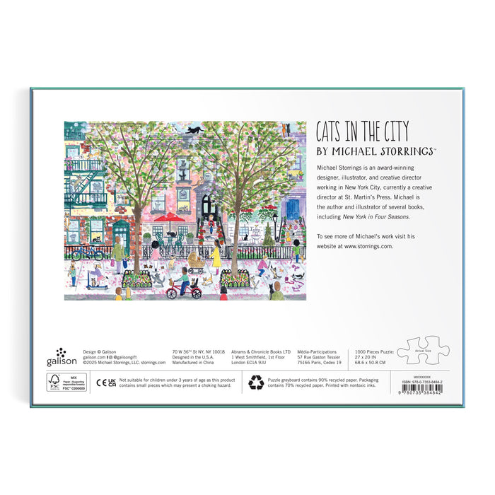 The back of the box displays vibrant city street art with trees, cats, and people. It highlights the Michael Storrings Cats in the City 1000 Piece Puzzle—perfect for puzzle lovers—and includes artist and product details.