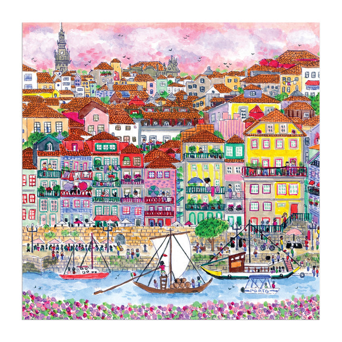 Michael Storrings Colors of Porto 500 Piece Puzzle by Michael Storrings features a colorful illustration of a lively European riverside town with vibrant houses, boats on the river, and a scenic hilly backdrop.