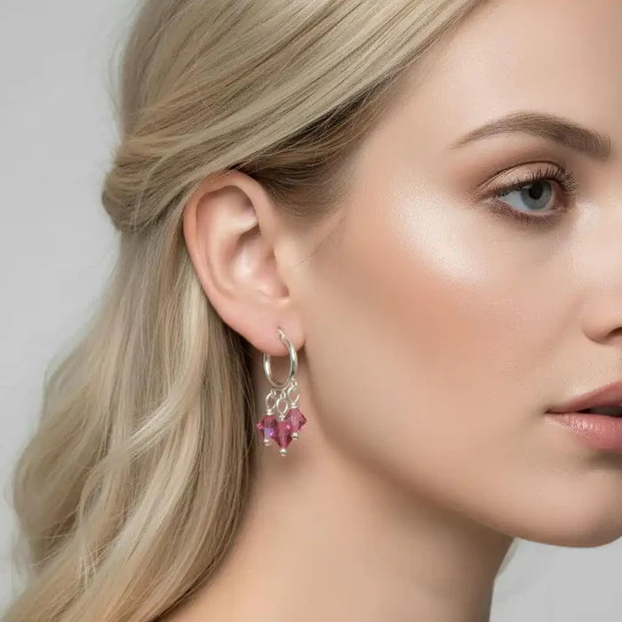 Mini Sterling Silver Hoop Pink Crystal Dangle Earrings worn by a model, showcasing vibrant pink Swarovski crystals.