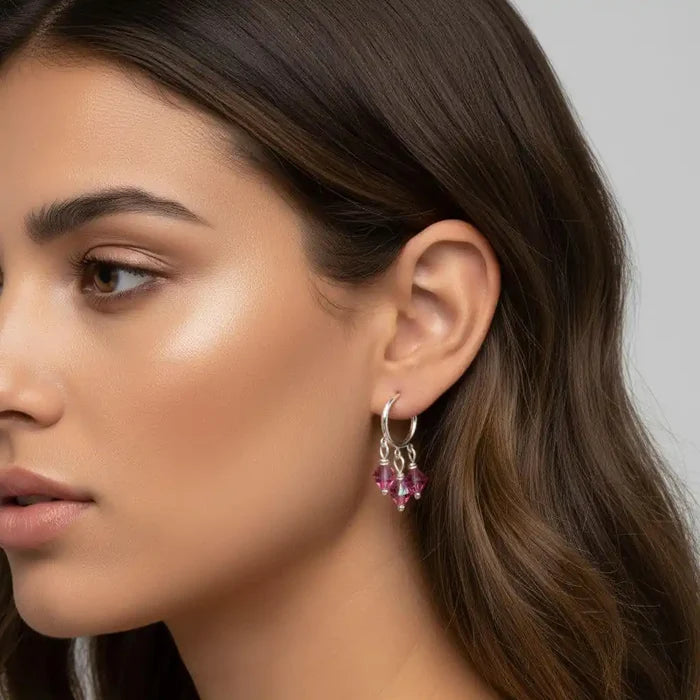 Mini Sterling Silver Hoop Pink Crystal Dangle Earrings worn by a model showcasing sparkle and style.