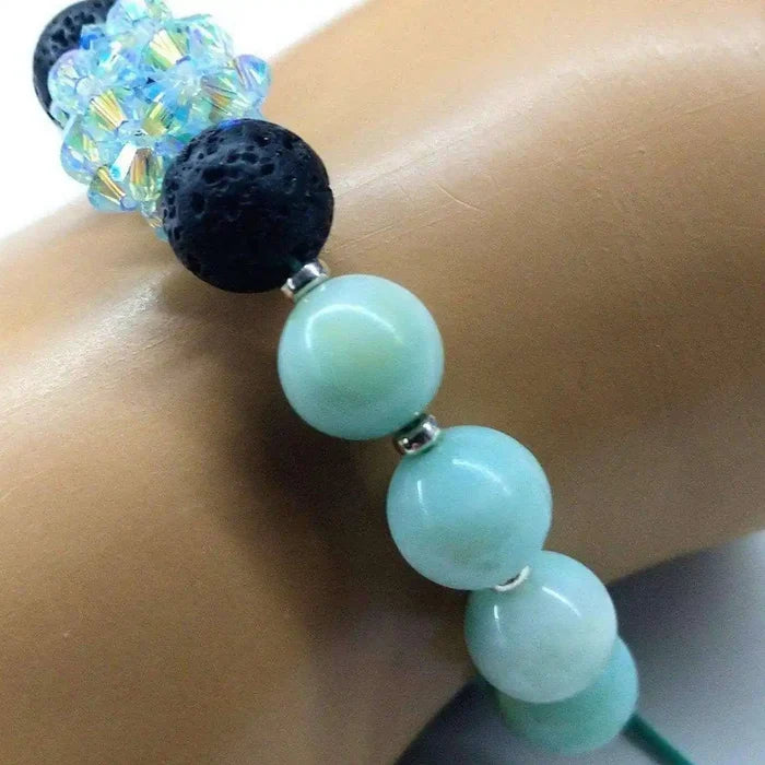 Mint Green Amazonite Gemstone Crystal Lava Rock Bracelet featuring blue and black beads on a hand model.