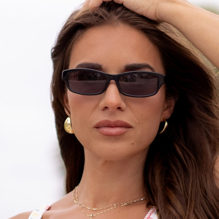 on model - female wearing diff eyewear x jessie james decker misty square sunglasses with a black acetate frame and grey polarized lenses front view