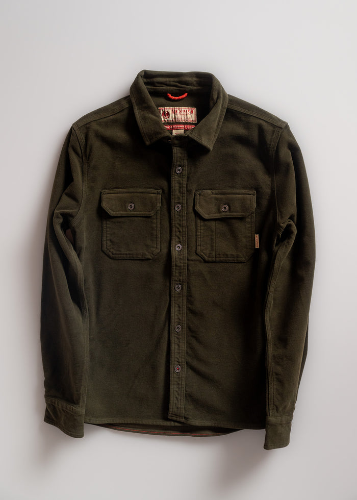 Olive green button-up shirt with two chest pockets, laid flat on a white background, showcasing its casual style and design.