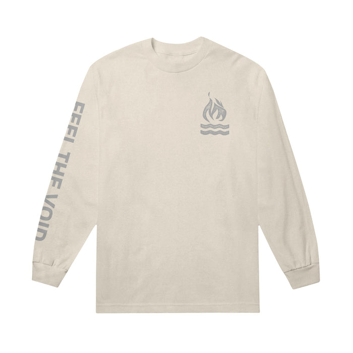 Ivory long-sleeve shirt with a fire symbol and 2 bold wavy lines below it printed on upper right side in a gray color. Left sleeve has "FEEL THE VOID" printed on it in same gray color.