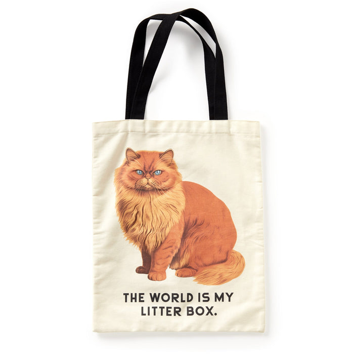 The Moody Cats Canvas Tote by Brass Monkey features a cream design with black handles, showcases a fluffy orange cat and THE WORLD IS MY LITTER BOX. text—perfect as a humorous gift for any feline fan.