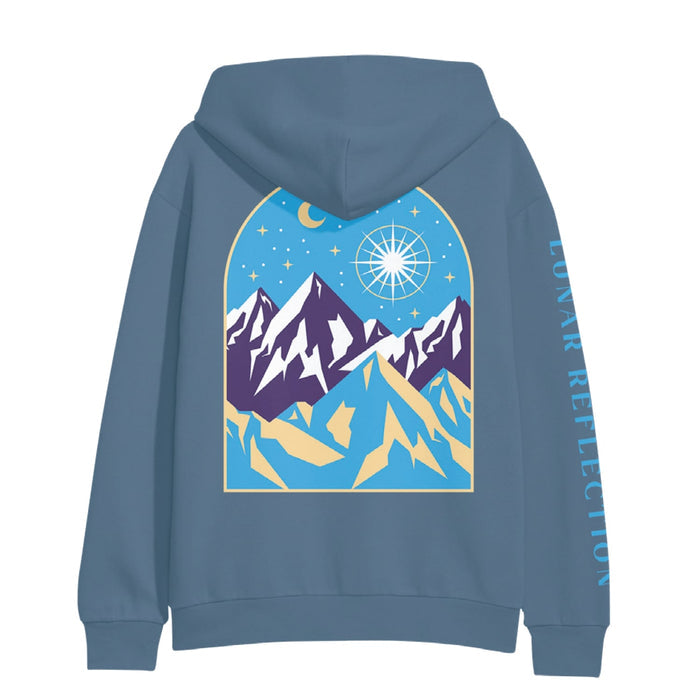 Back of indigo colored hoodie with a drawing of mountains and a night sky. There is a star drawn brightly shining next to the moon above a mountain range.