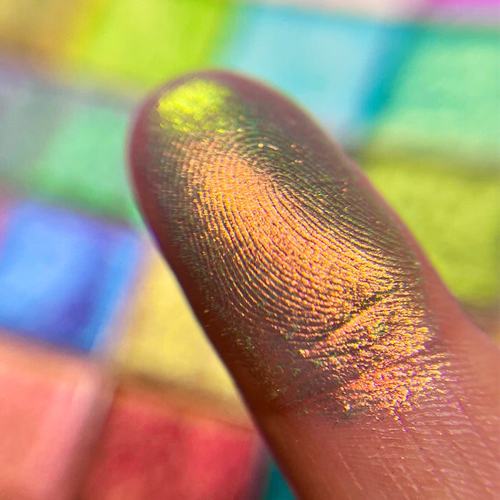 Close up finger swatch on fair skin of Mural Electric Multichome eyeshadow
