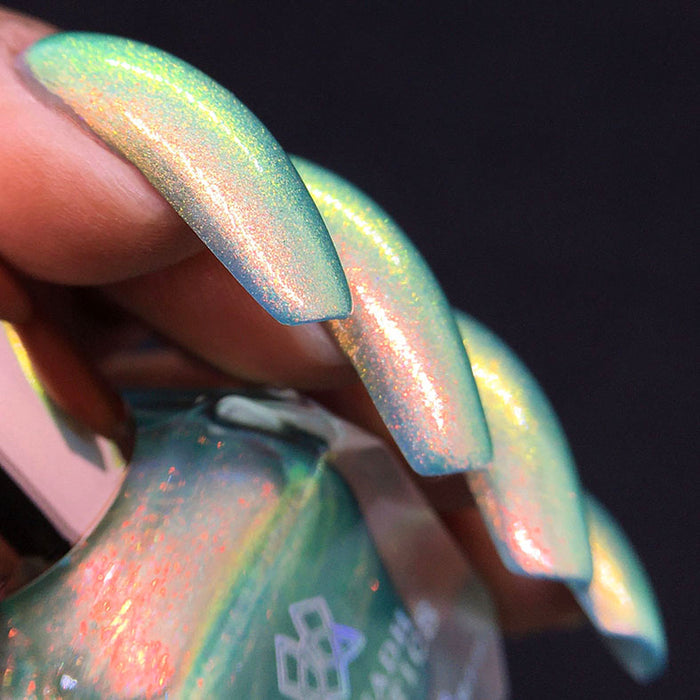 Left angled shot of nails done with Mural Nail Lacquer on medium skin tone