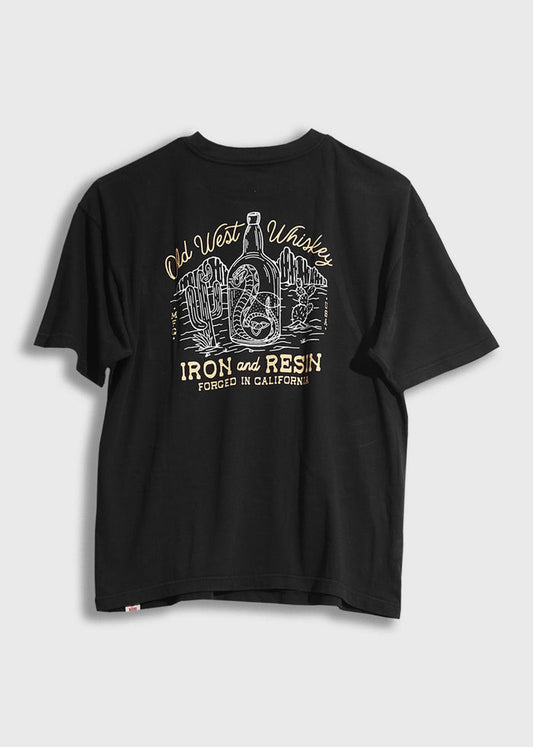 Black T-shirt with "Old West Whiskey" and "Iron and Resin" print, featuring a bottle and cacti, forged in California.