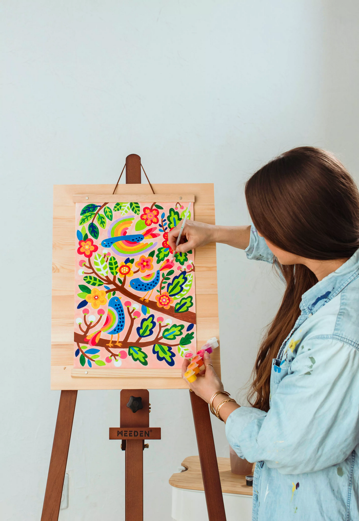 Girl painting canvas on easel from OOLY Paintology Paint-By-Number Canvas Kit - Blue Birds