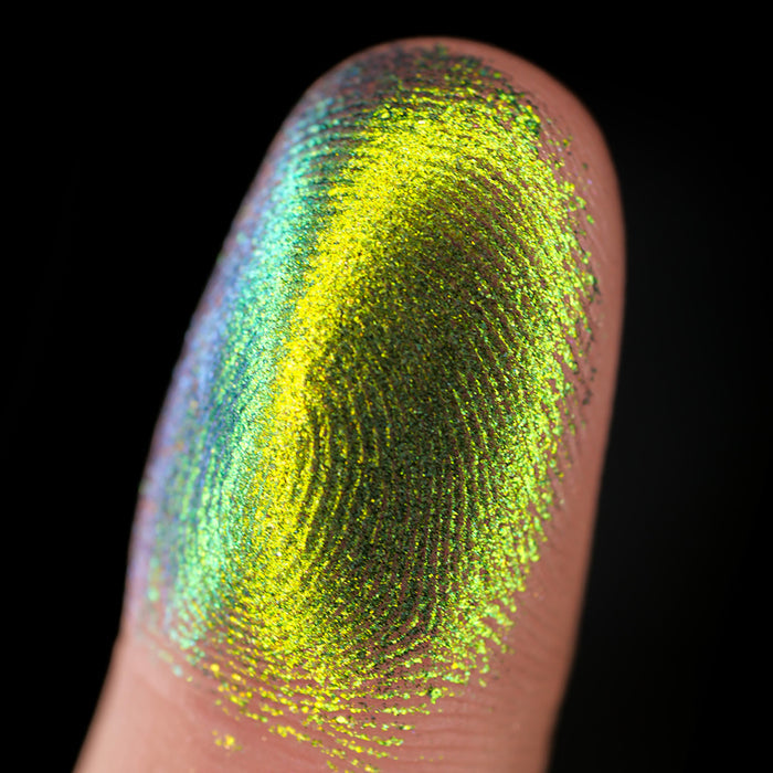 Macro finger swatch of Patina Lite on fair skin tone.