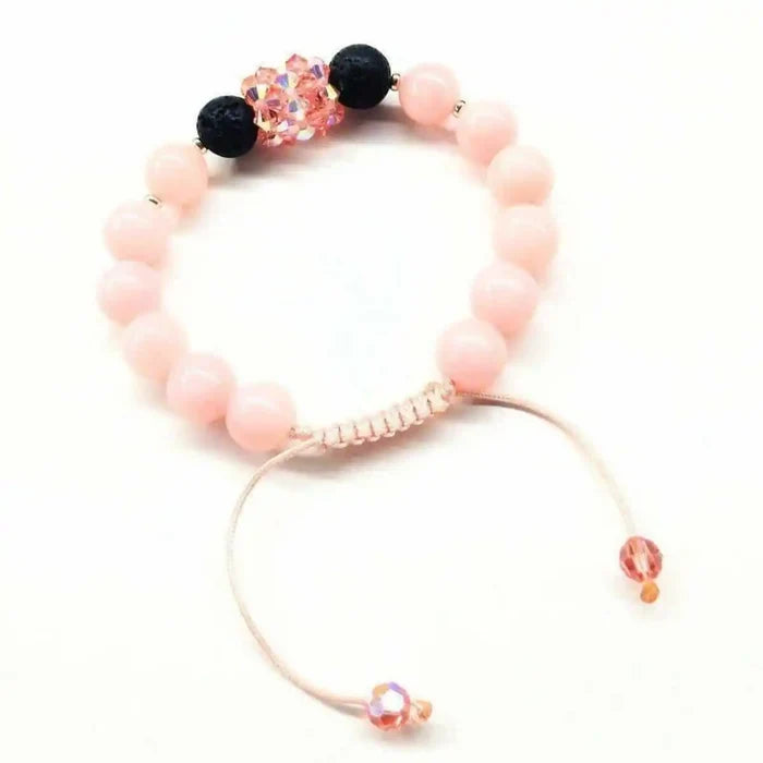Peach Corral Jade Gemstone Crystal Lava Rock Bracelet showcasing pink jade and black lava rock beads.