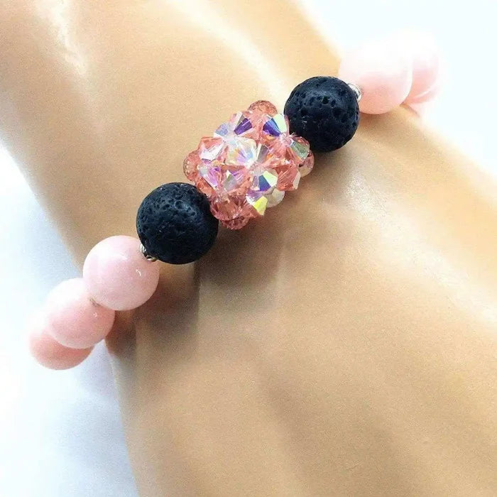 Peach Corral Jade Gemstone Crystal Lava Rock Bracelet featuring pink gemstones and lava rock beads on a wrist.